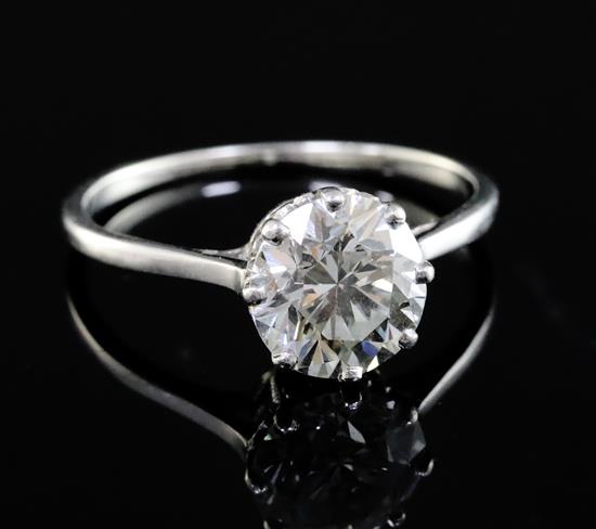 An 18ct gold and platinum set solitaire diamond ring, size N.